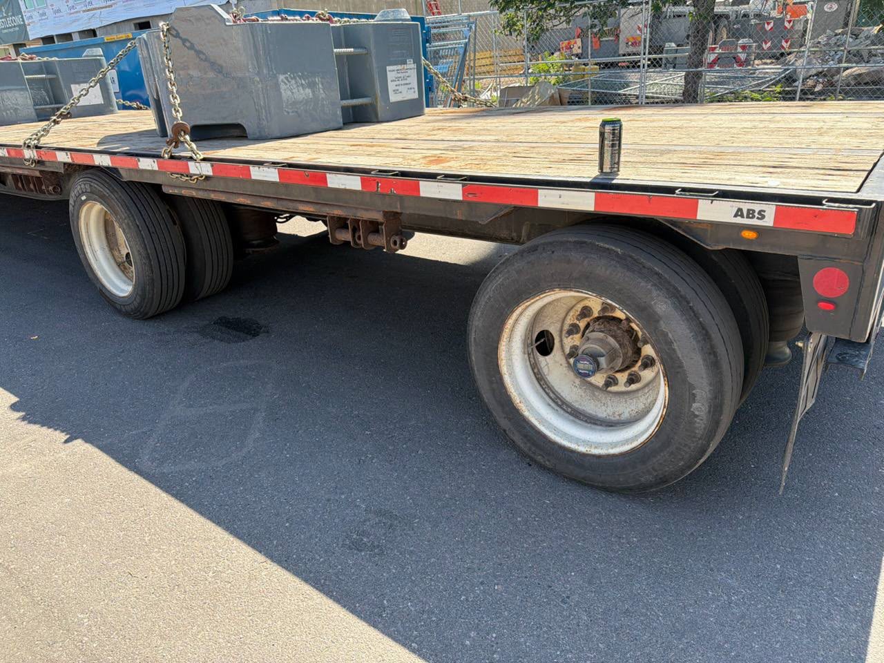 Flatbed tow truck loading a vehicle for a Roadmate customer