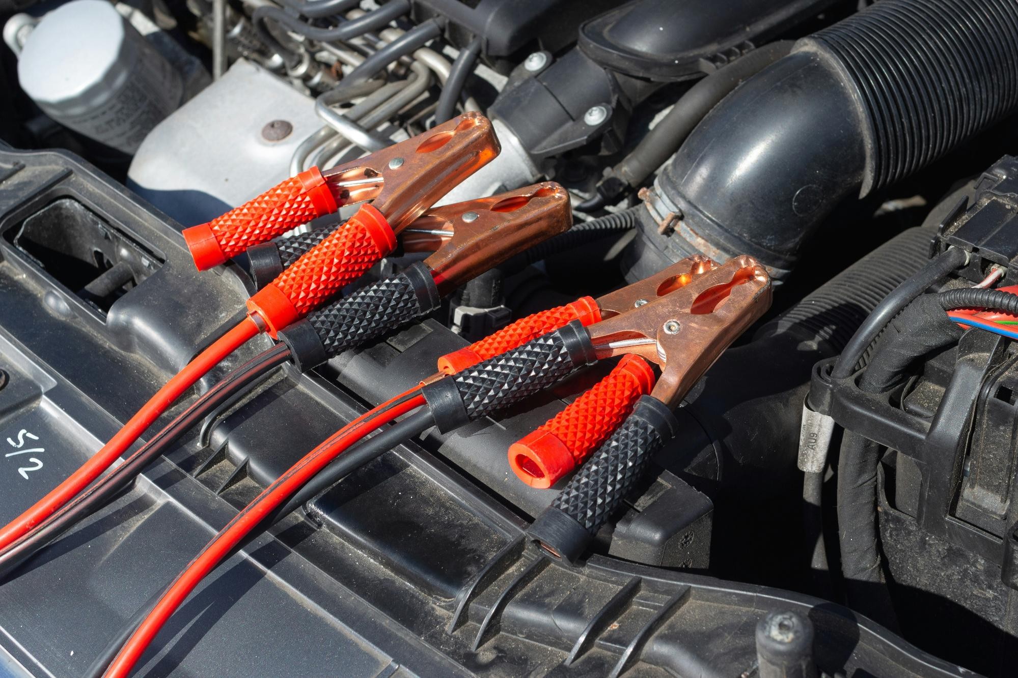 Jumper cables connected to a car battery