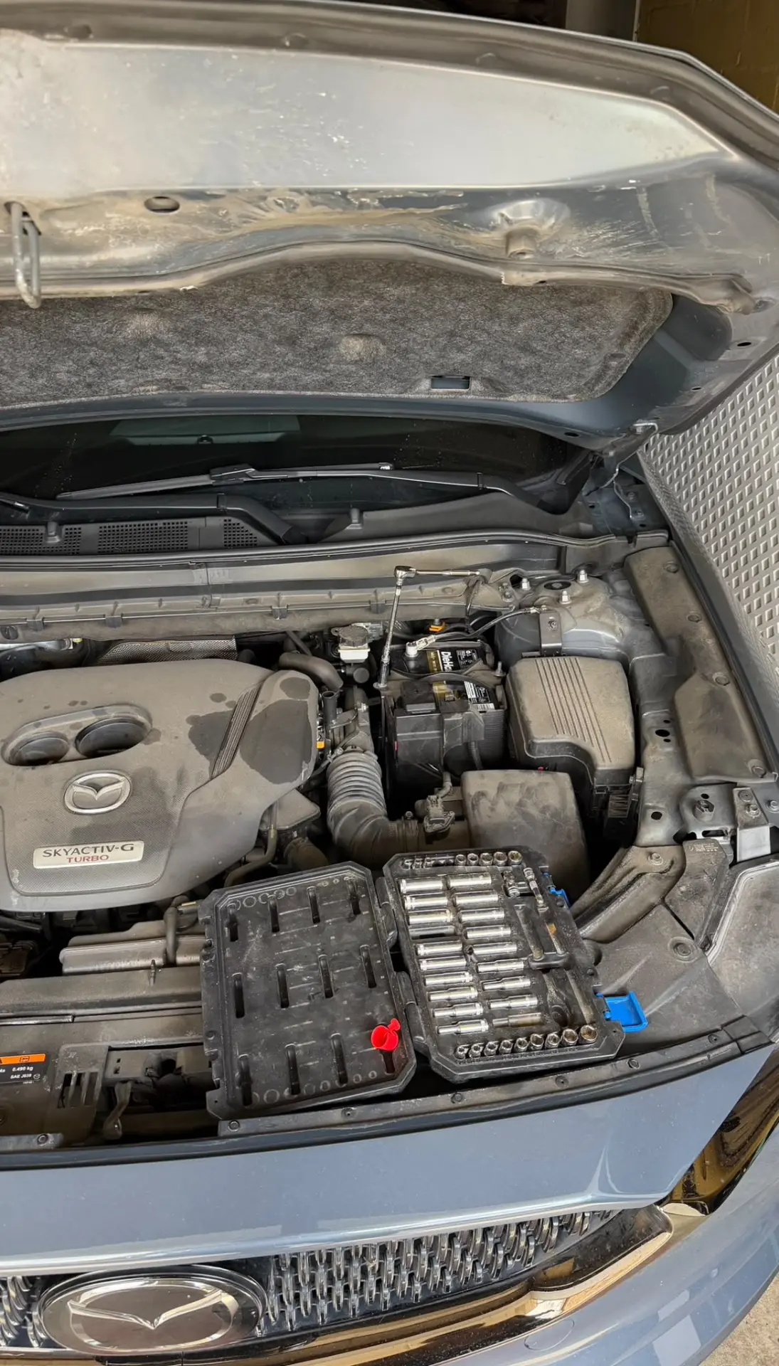 Battery replacement on a Mazda CX-5 with tools in Columbus, OH