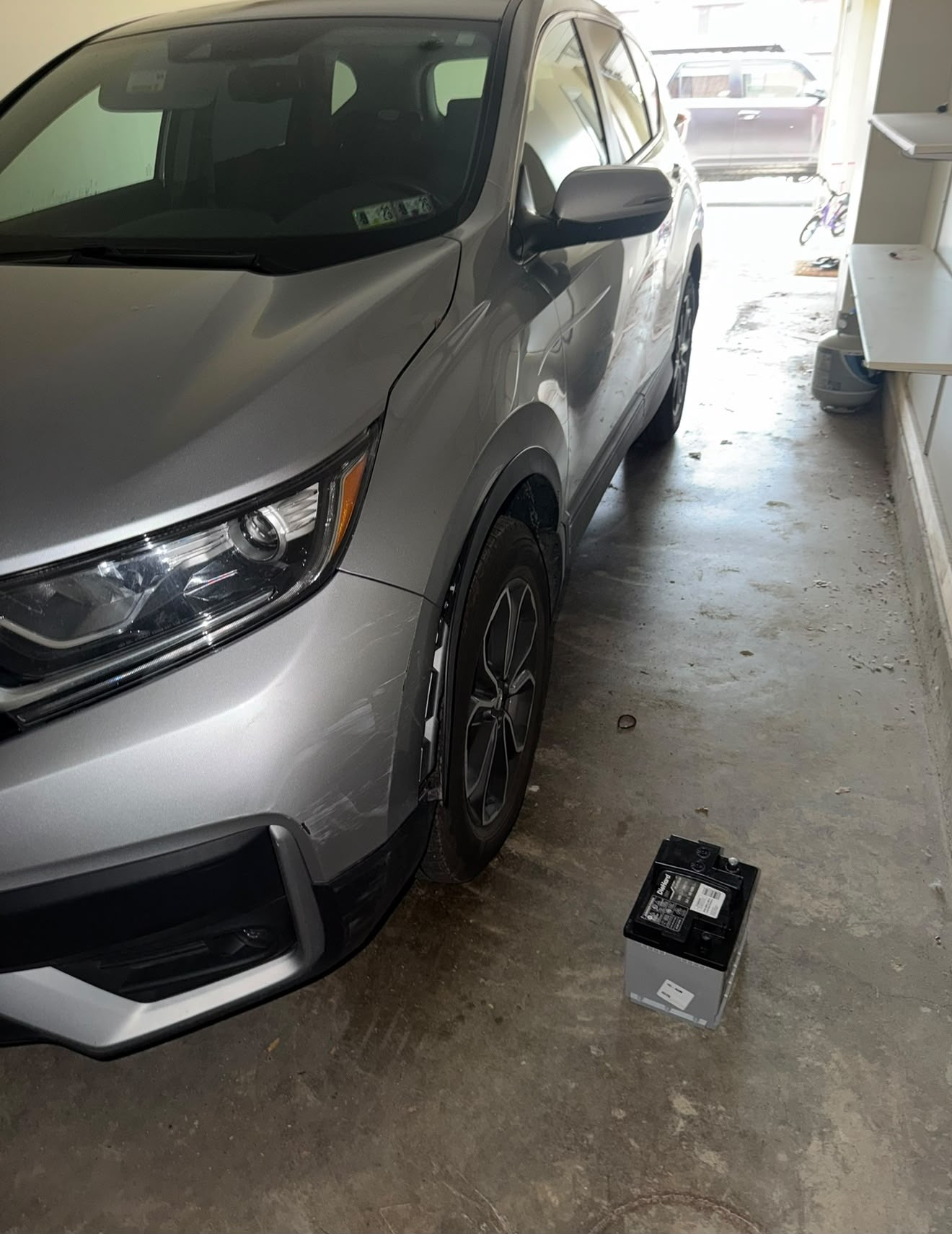 Battery replacement on a silver Honda CR-V in a Columbus garage