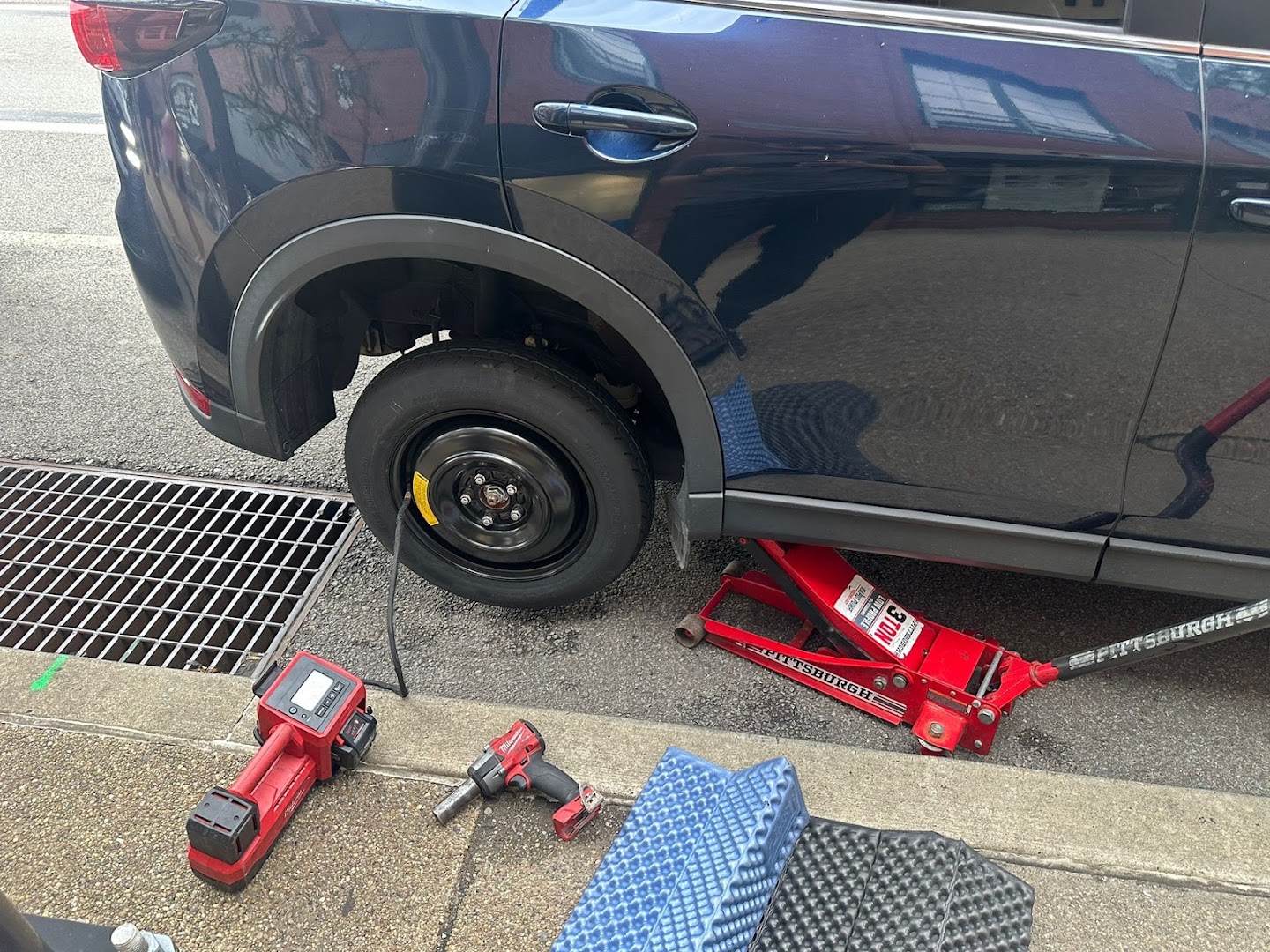 Flat tire change performed roadside by a Roadmate technician