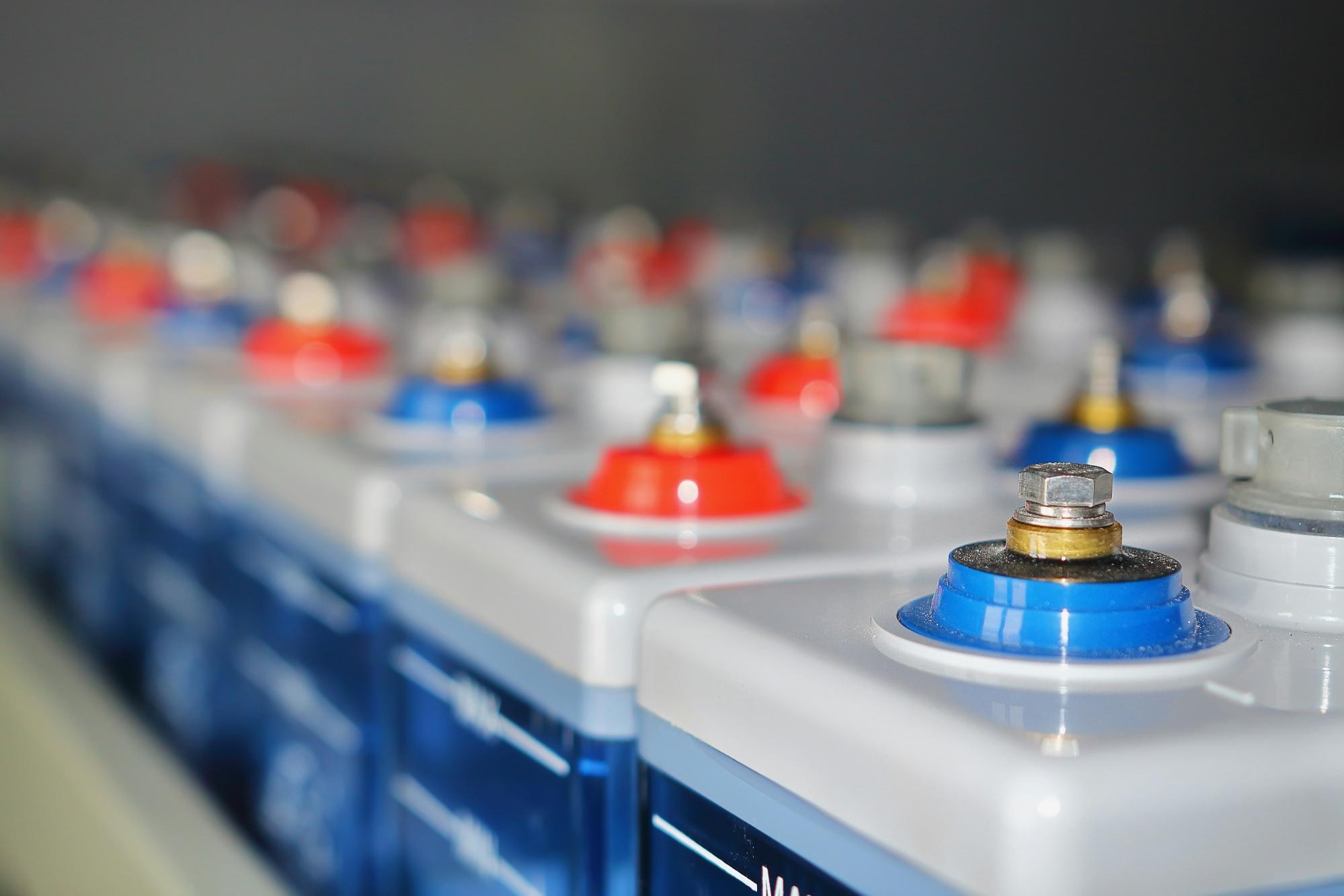 Close-up of several car battery terminals in a row